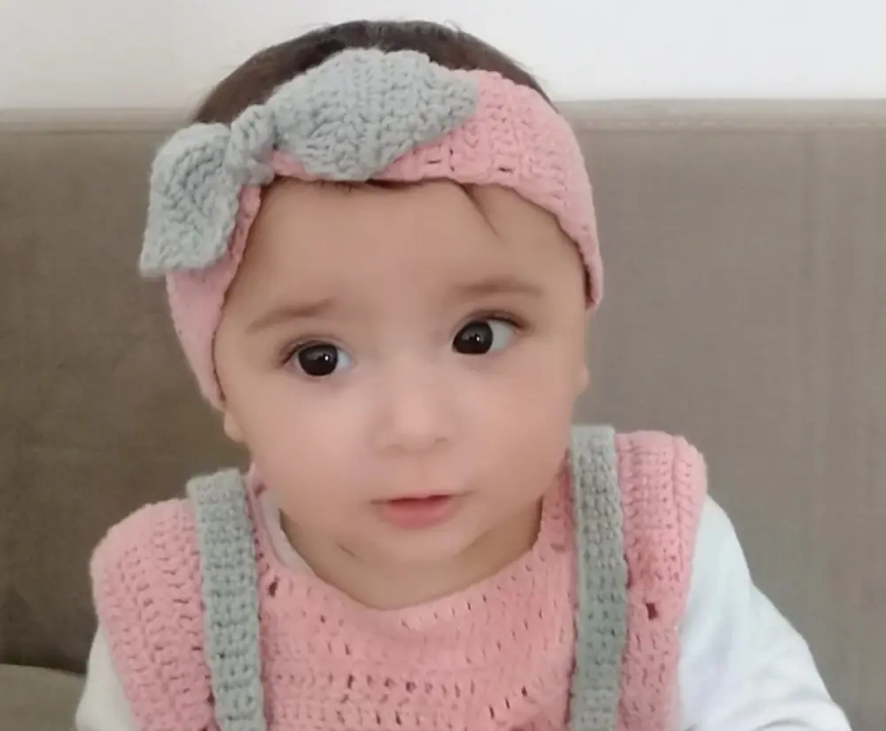 image of baby with a bow headband