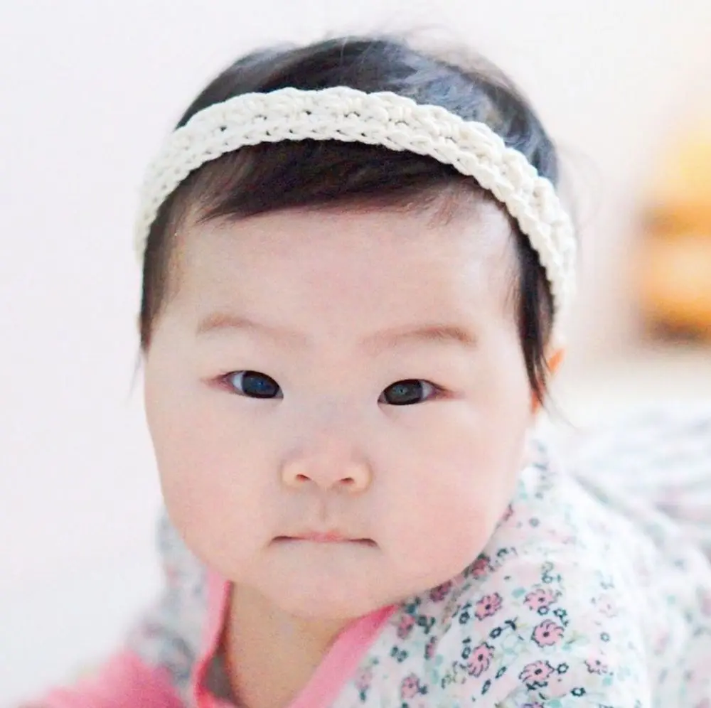 image of a baby with a white headband