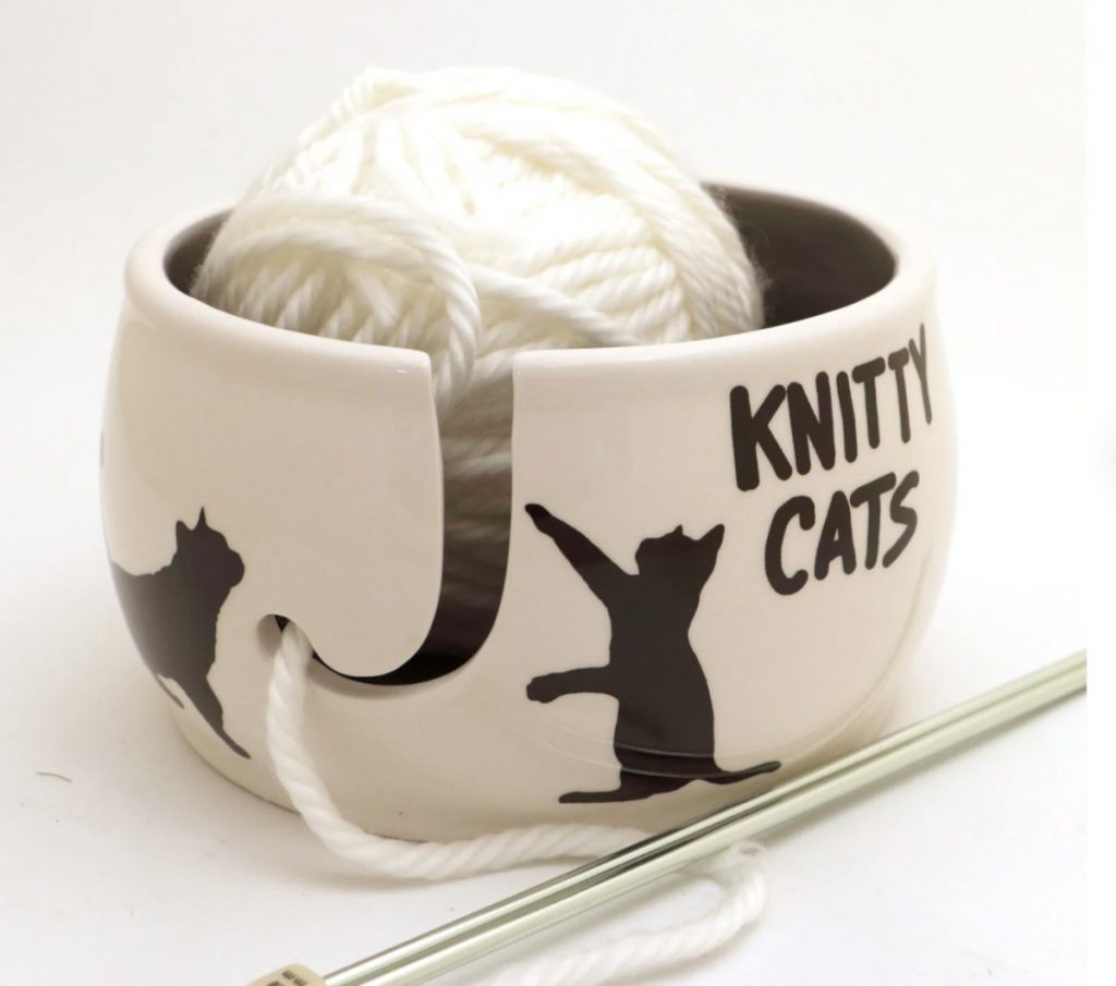 White ceramic yarn bowl with painted cats and the text "Knitty Cats"