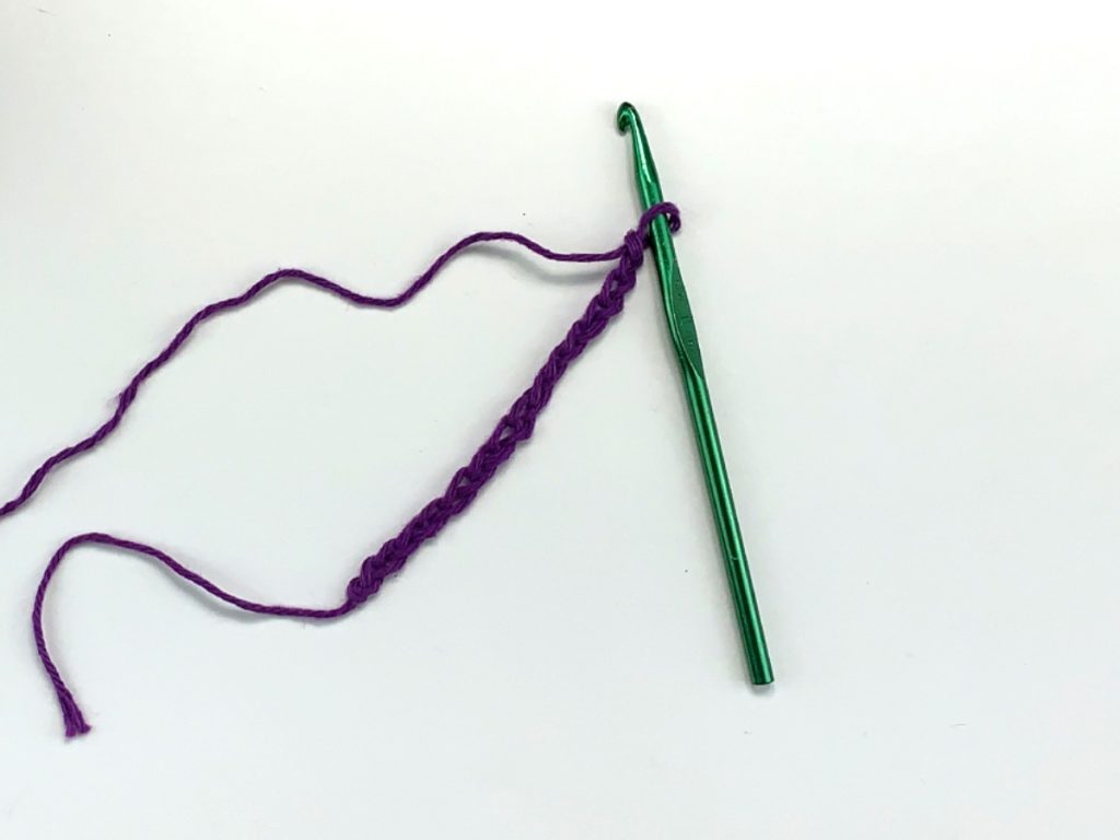 A crochet chain with purple yarn