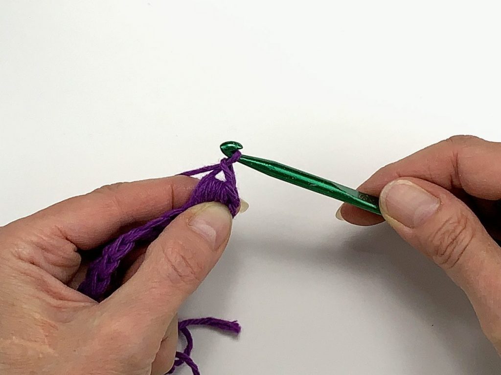 A loop of yarn pulled through a stitch