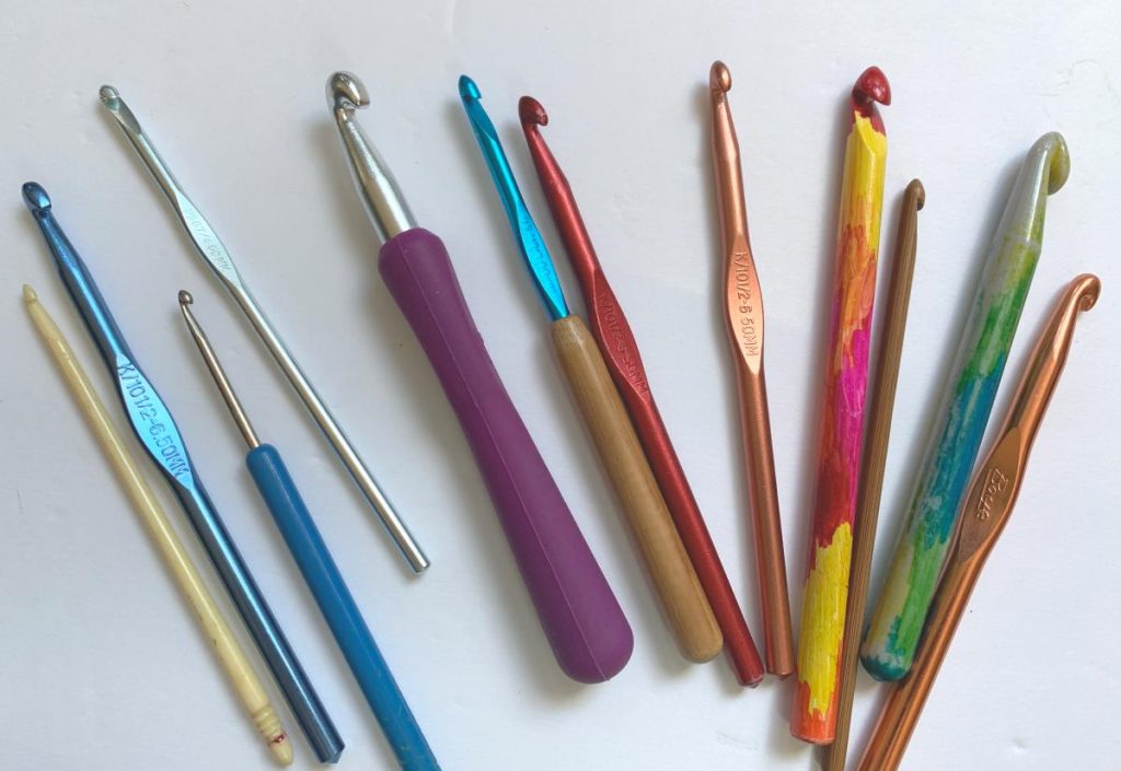 a selection of different crochet hooks on a white background