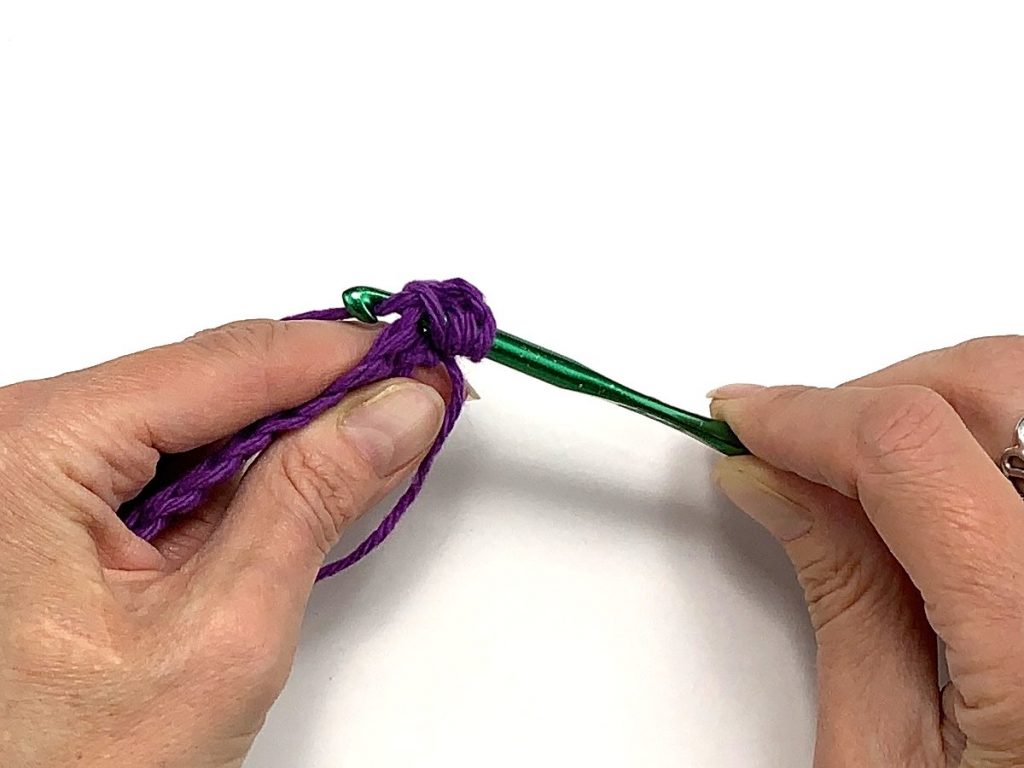 Crochet hook grabbing yarn