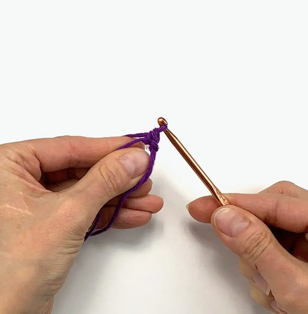 image of hands crocheting a single stitch
