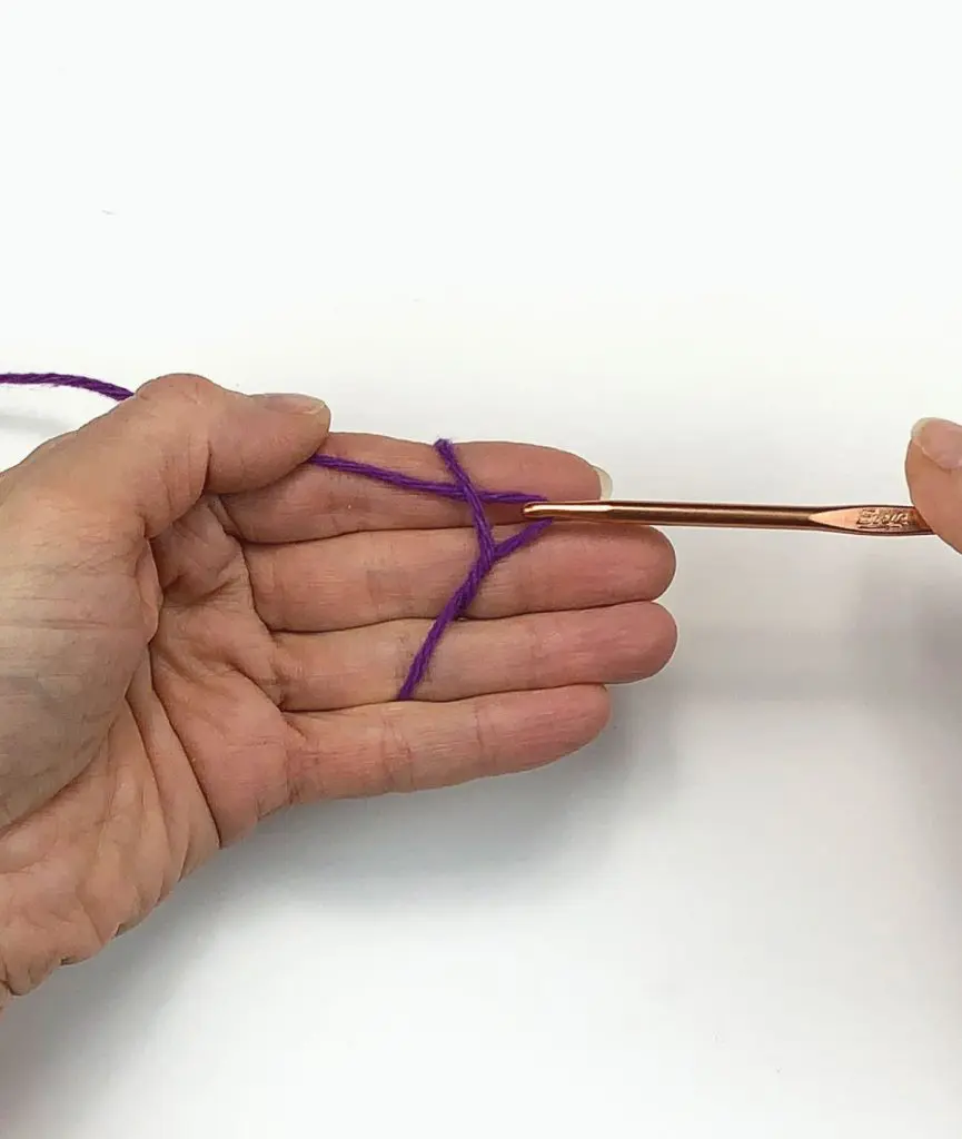 image of hand pulling yarn with a crochet hook