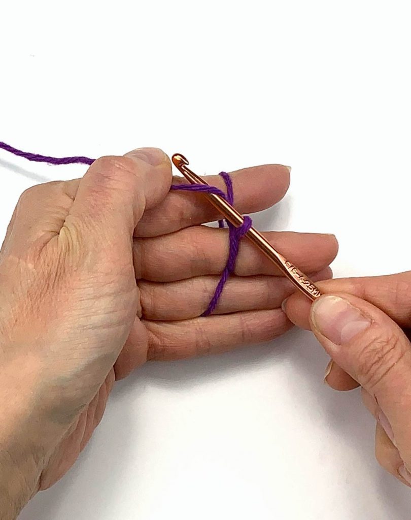 image of hands yarning over with a crochet hook