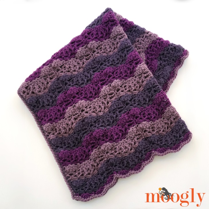 image of a crochet blanket in various purple stripes