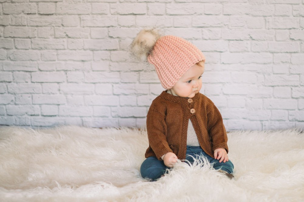 image of a baby wearing a crochet sweater and hat