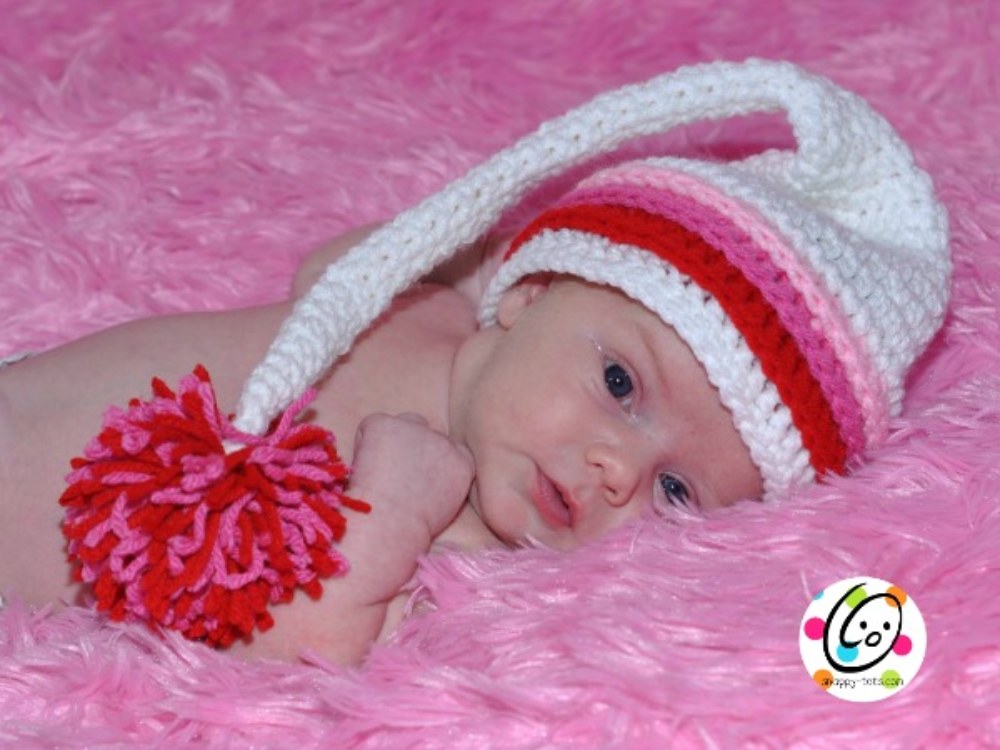 image of a baby wearing a white and pink crochet hat