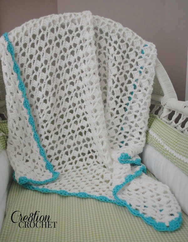 image of white baby blanket with turquoise border