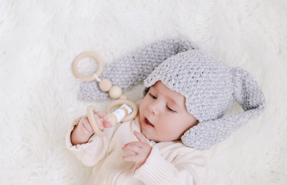 image of a baby with a gray bunny crochet hat