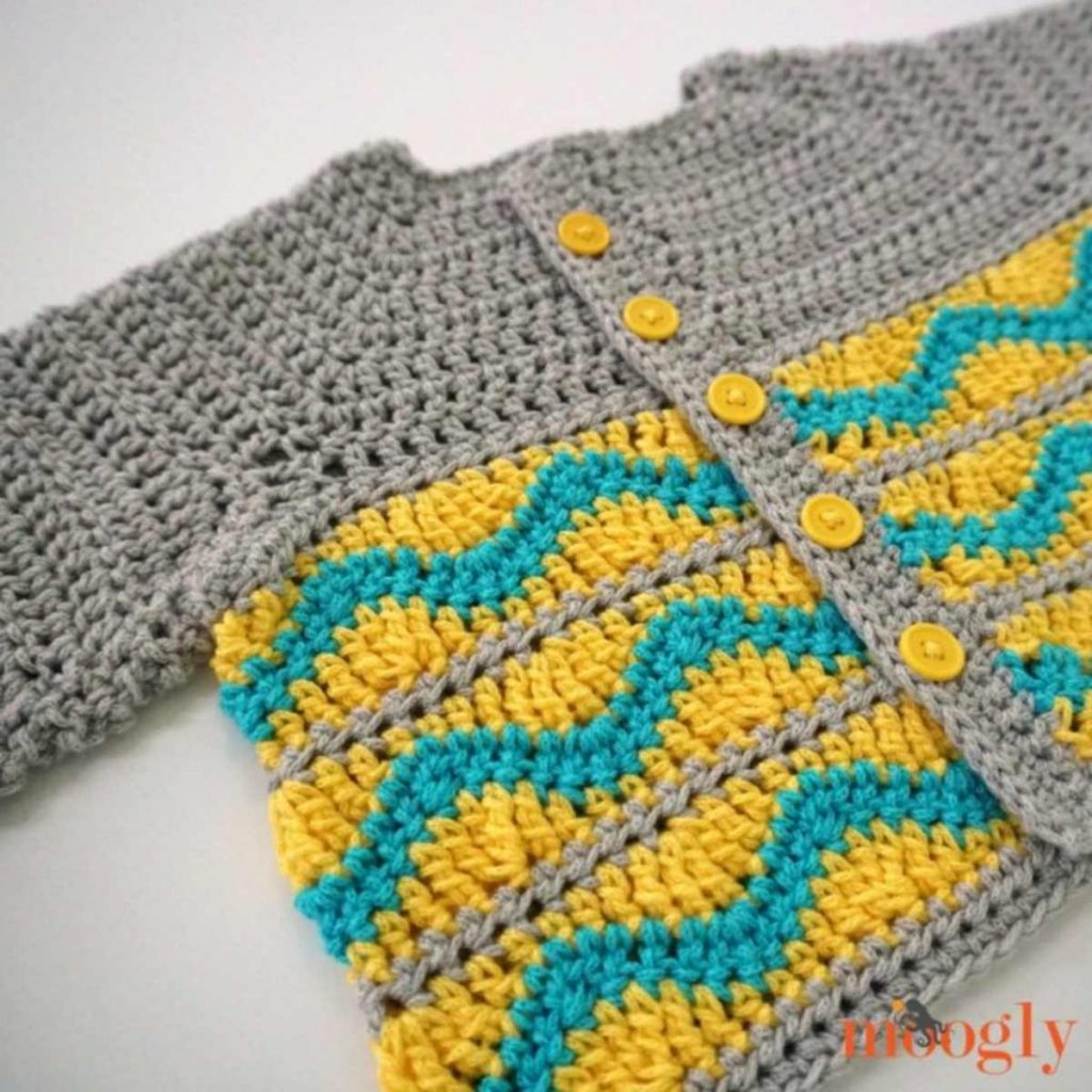 image of a gray crochet sweater with yellow and blue stripes