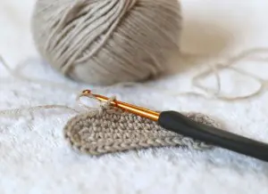 image of tan crochet work and hook